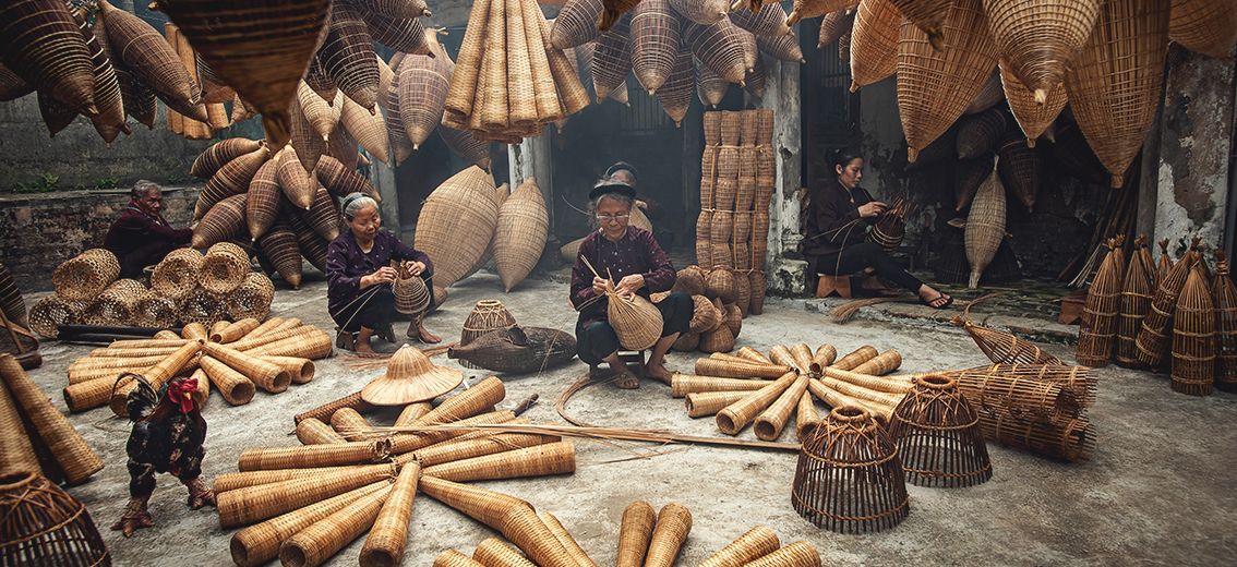 Handwerkerinnen bei der Herstellung einer Fischfalle aus Bambus in Hung Yen